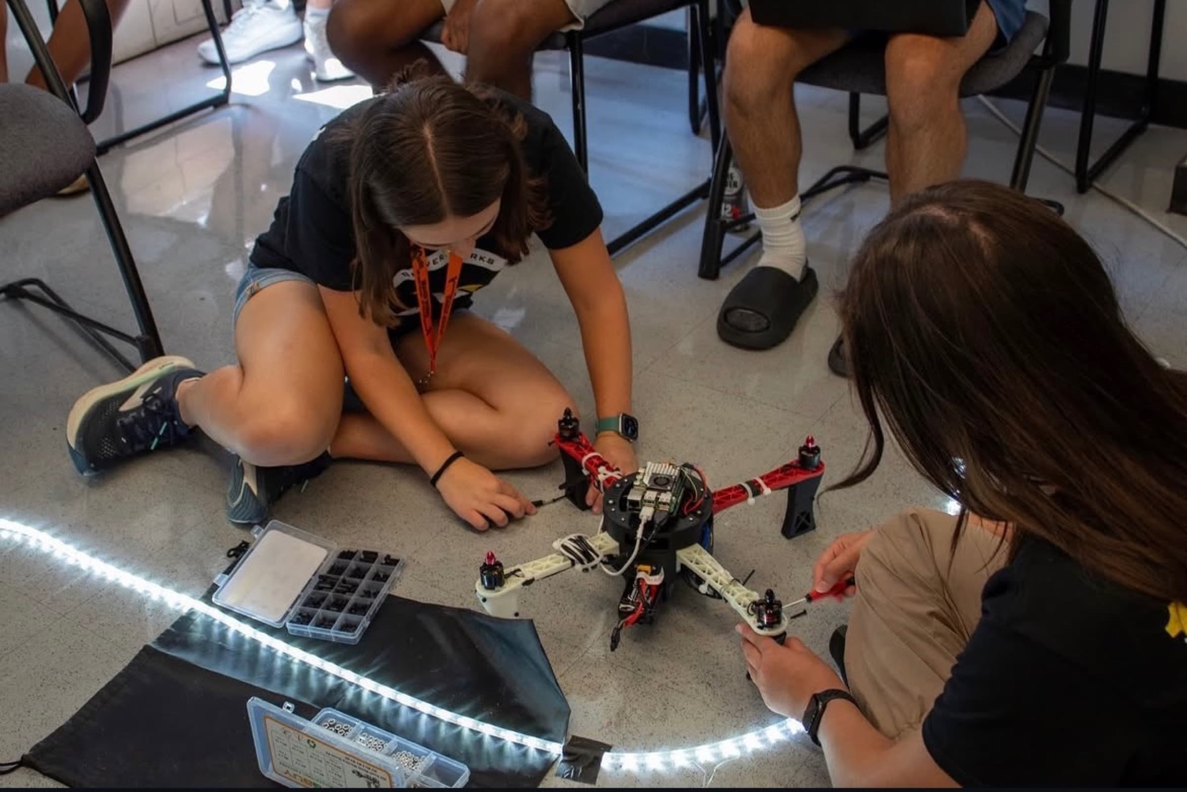 My teammate and I working on installing the legs I designed and printed, which another team later on used.